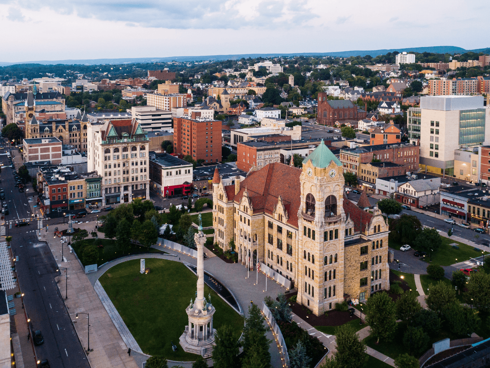 Aerial view of a cityscape featuring historic architecture and green spaces.