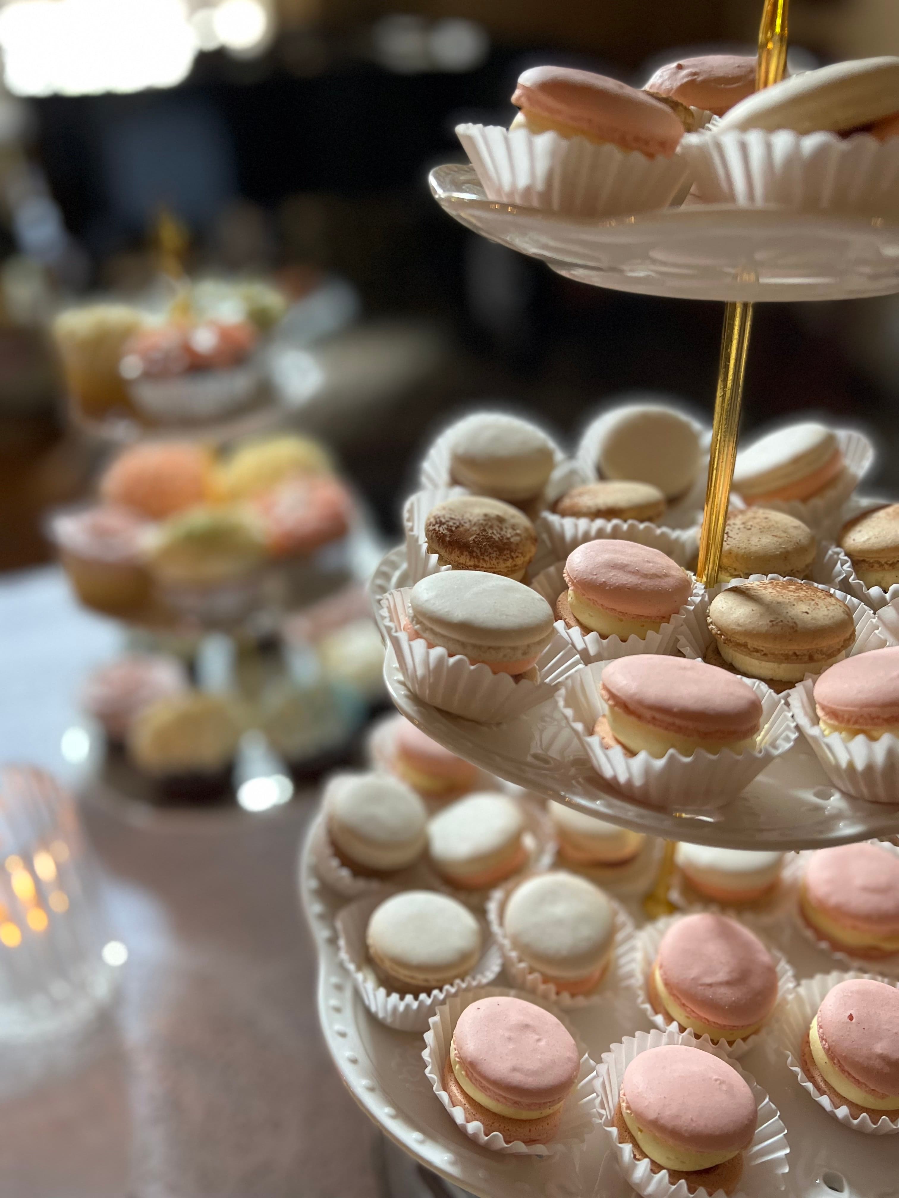 A tiered stand filled with colorful macarons.