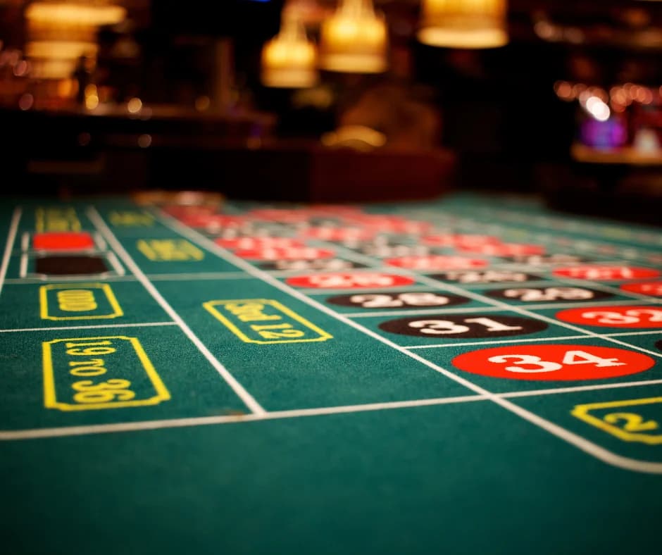 Cropped view of a roulette table with numbers and colored sections.
