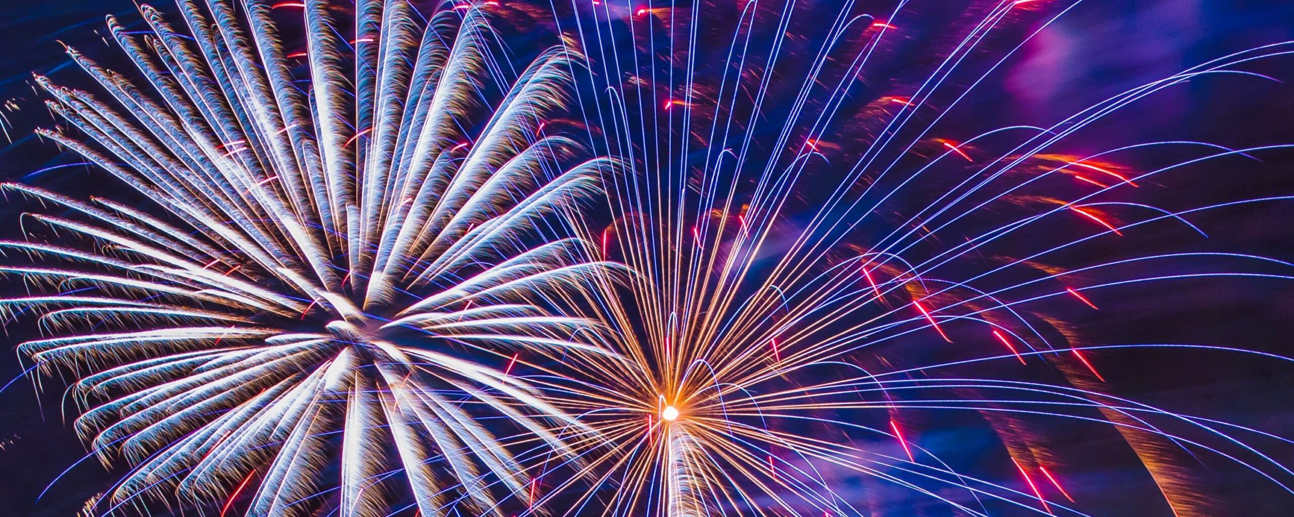 Colorful fireworks bursting in a night sky.