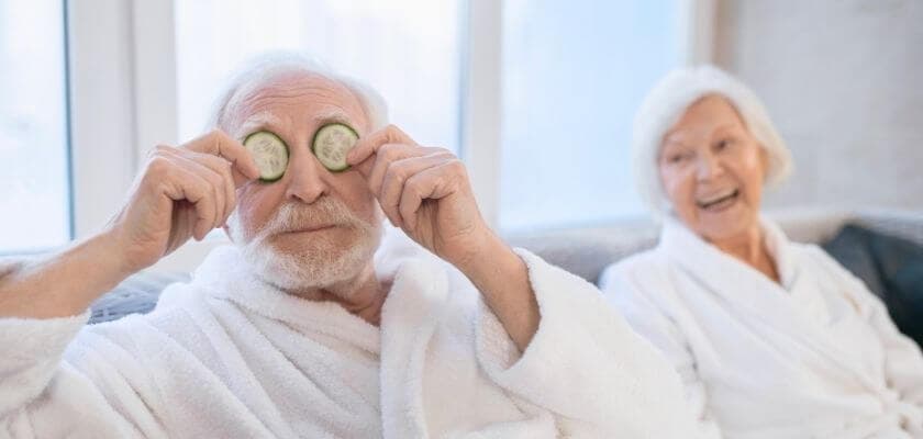 couple in white robes relaxing and goofing around at spa