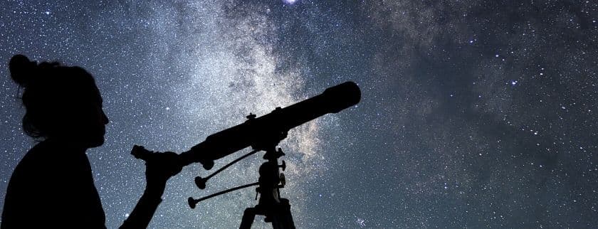 woman with telescope watching the stars