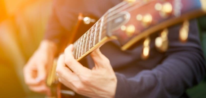 closeup of a person playing an electric guitar